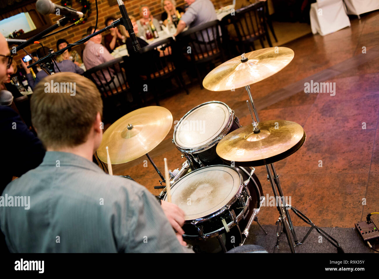 drummer in the hall, live music in the restaurant, play the drum set Stock Photo