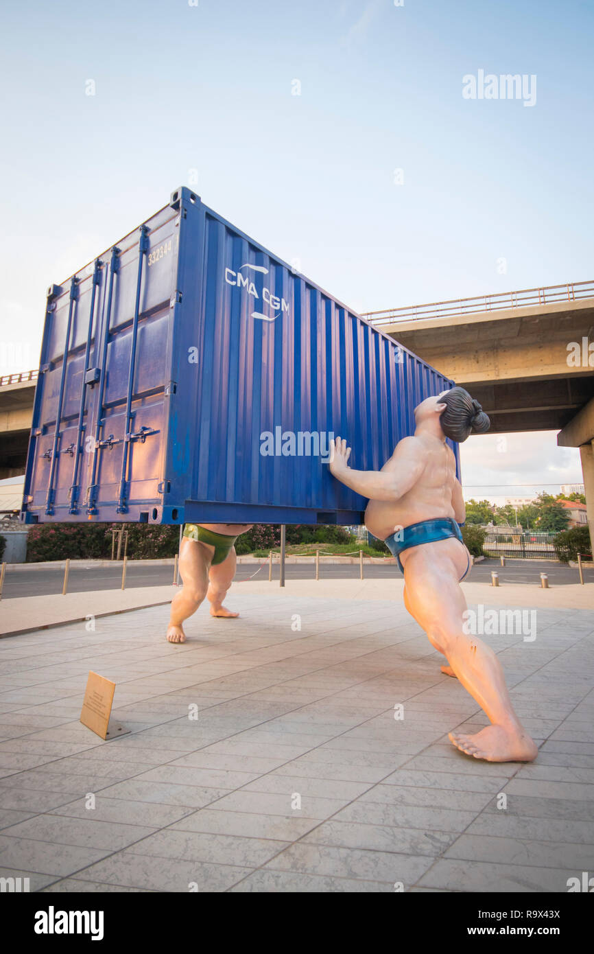 'takes two to tango' sculpture by Scottish artist David Mach of 2  chinese sumo wrestlers lifting a shipping container La Fondation CMA-CGM Marseilles Stock Photo