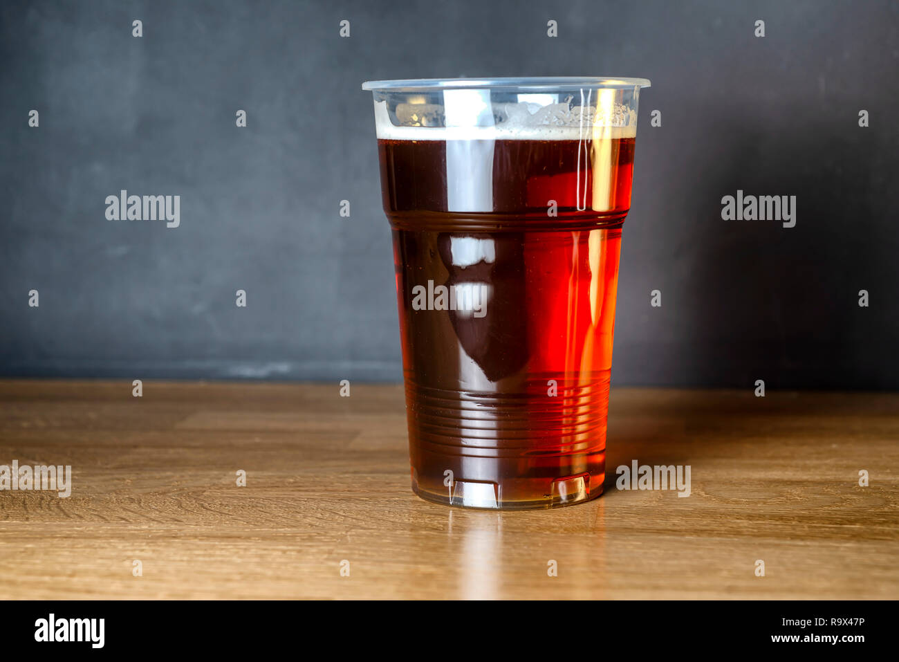 Invitation to a student beer party. A glass of cheap craft beer Stock Photo