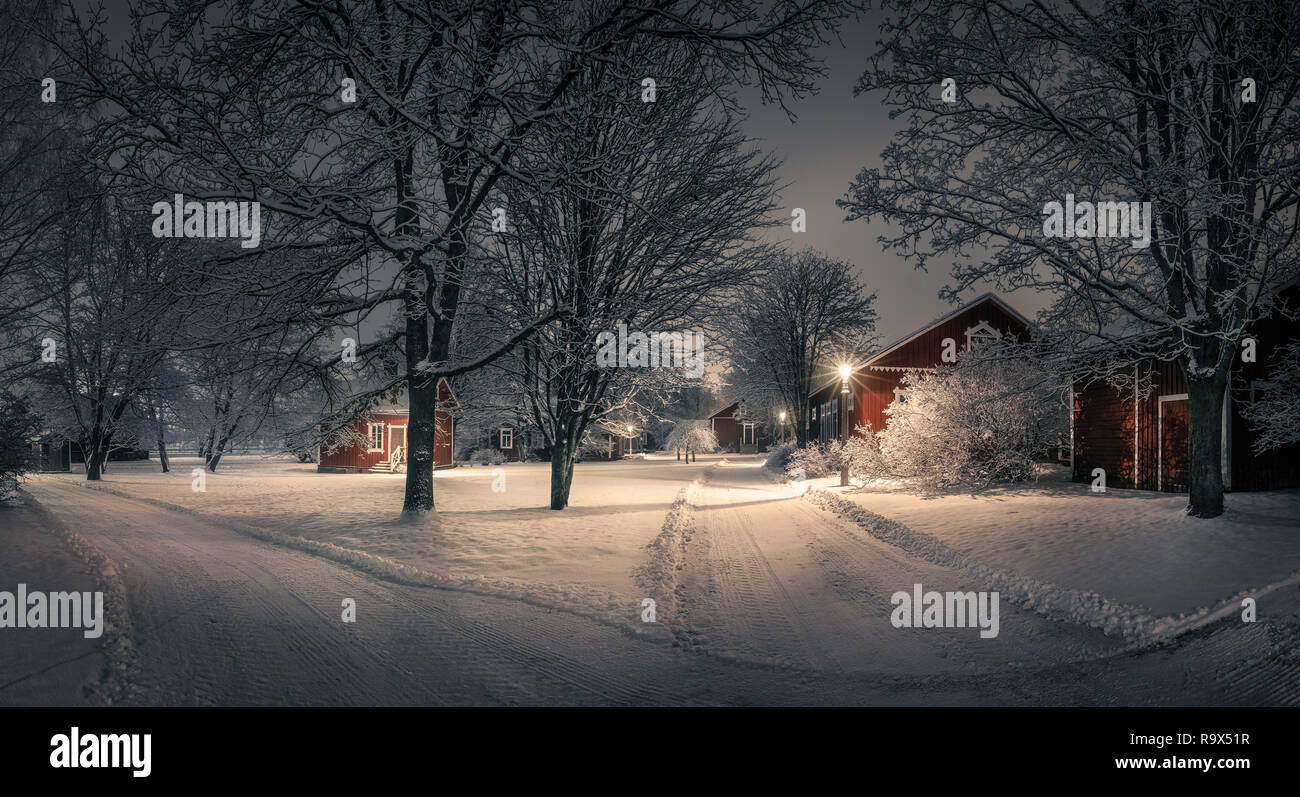 Public park with cozy cafe place and snow covered trees at winter evening in Finland. Cafe place is open only in summertime. Stock Photo