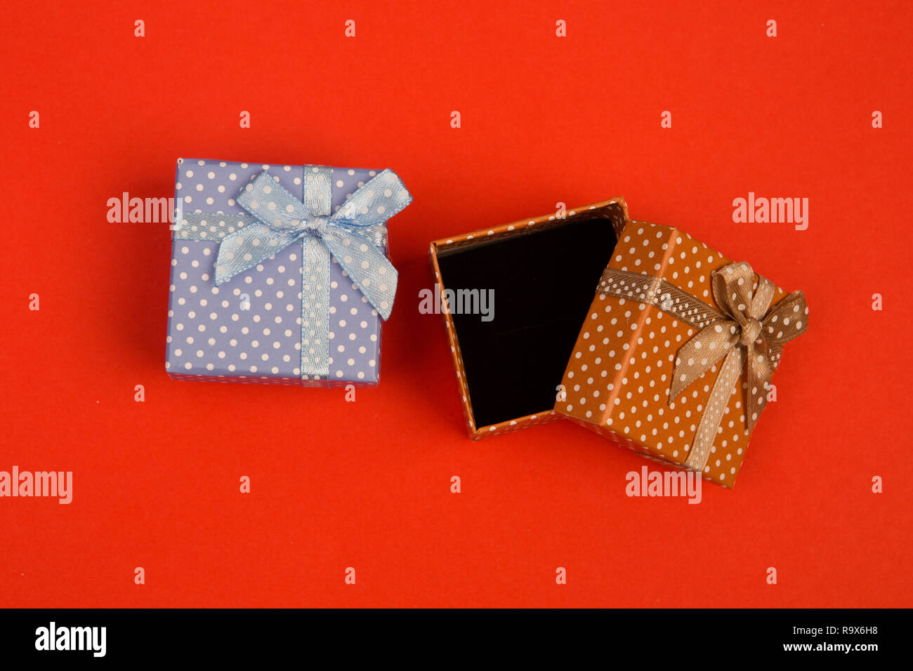 Celebratory concept - gift boxes in polka dots on red background Stock ...