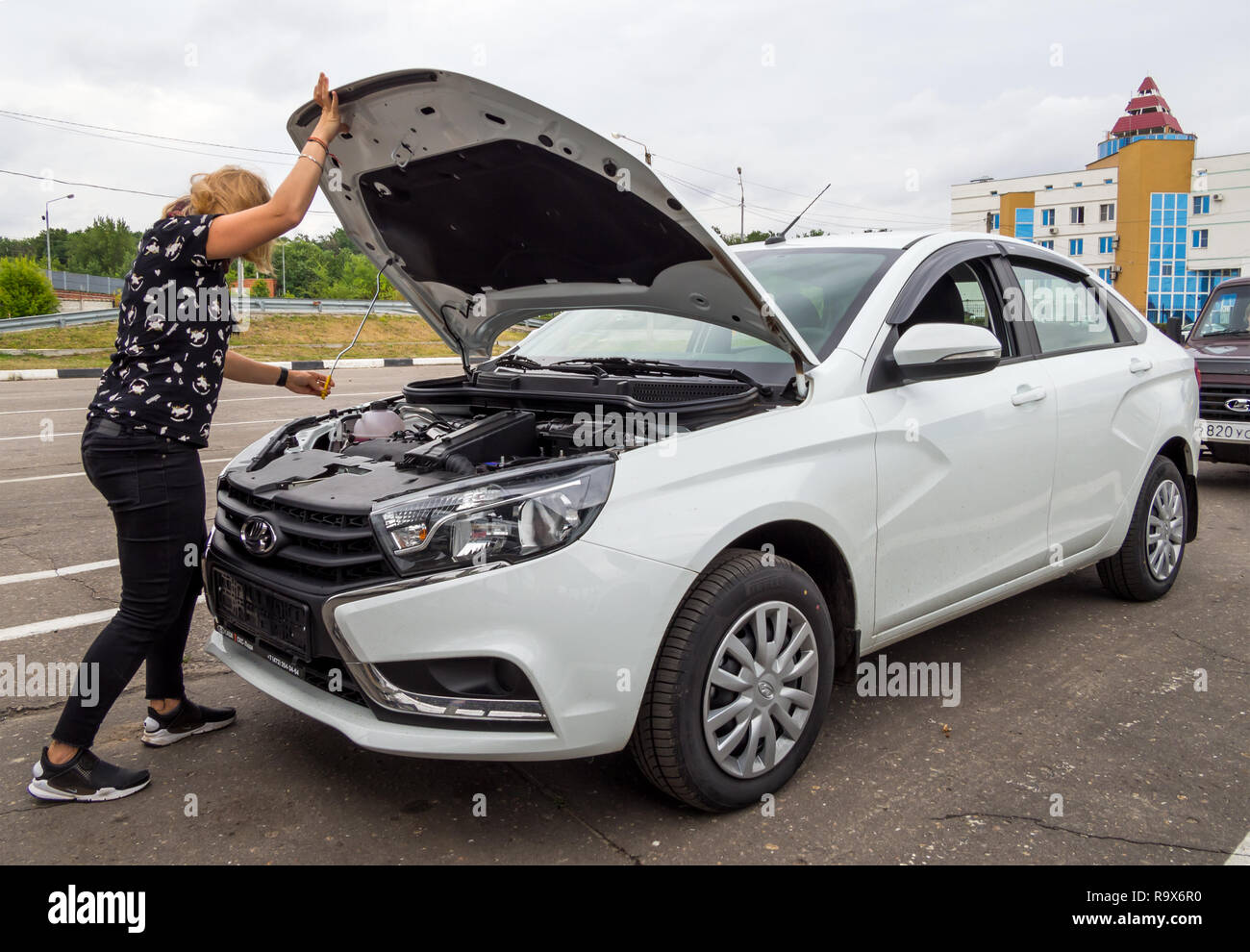 Voronezh, Russia - July 17, 2018: The girl opens the hood of a new car Lada  Vesta Stock Photo - Alamy