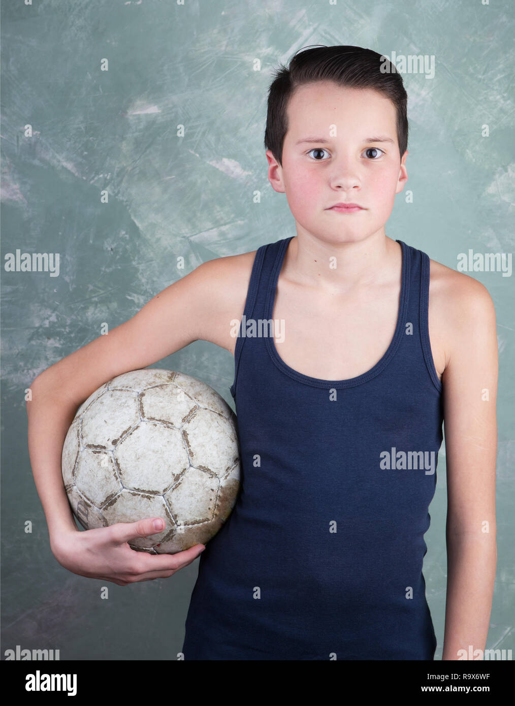 Portrait Of A Young Boy With Old Soccer Ball On Green Background Stock Photo Alamy Portrait Of A Young Boy With Old Soccer Ball On Green Background Stock Photo Alamy