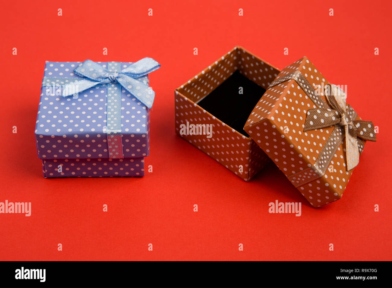 Celebratory concept - gift boxes in polka dots on red background Stock ...
