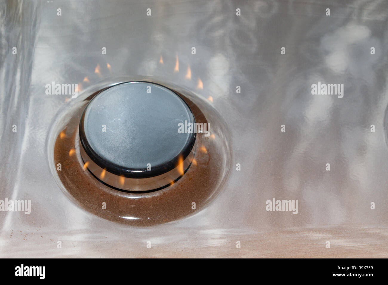 Gas stove with burning orange and blue fire on it Stock Photo Alamy