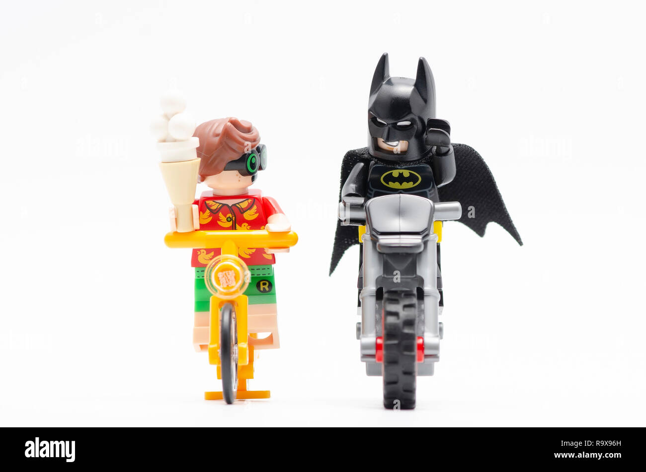 lego batman with robin riding bicycle with radio at his back and holding a  ice cream. Lego minifigures are manufactured by The Lego Group Stock Photo  - Alamy