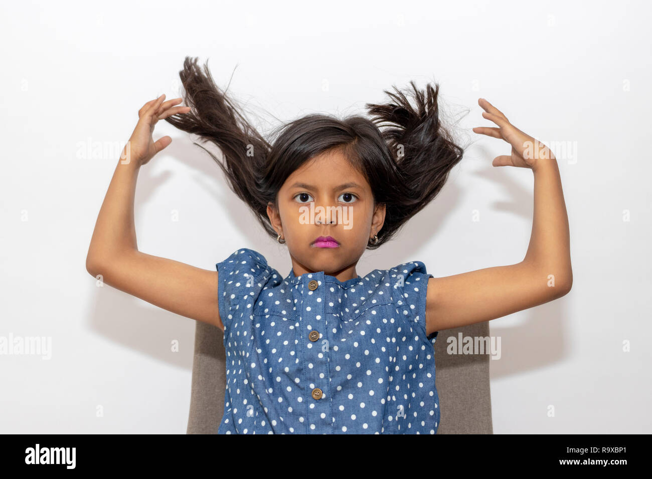 Little girl playing with her hair Stock Photo Alamy