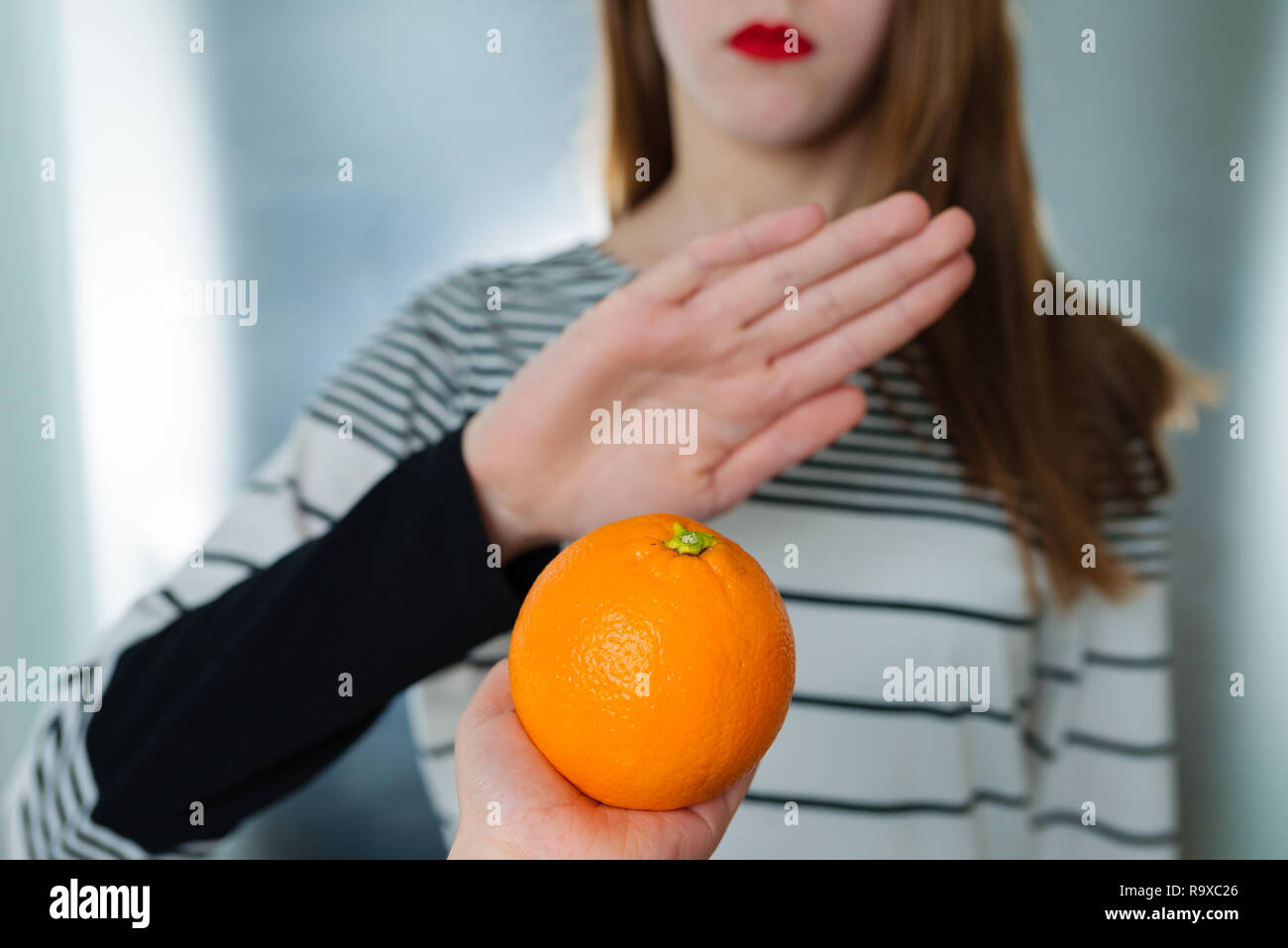 Citrus fruit allergy concept food intolerance. Young girl refuses to