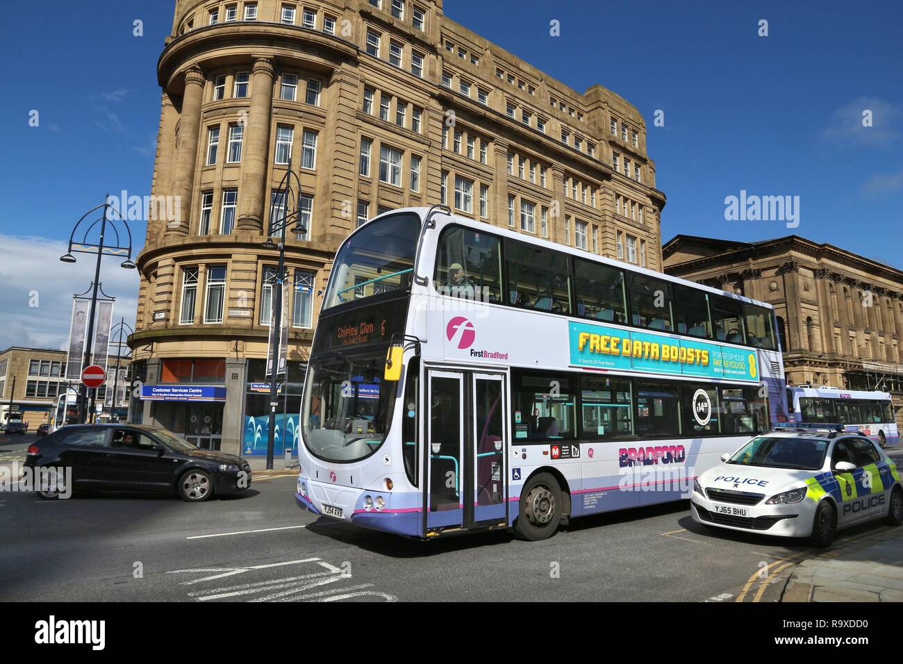 BRADFORD, UK - JULY 11, 2016: People ride First Bradford double decker bus. FirstGroup employs 124,000 people. Stock Photo