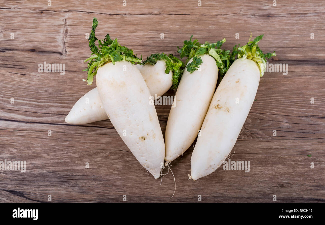 Daikon radish on the wood background Stock Photo