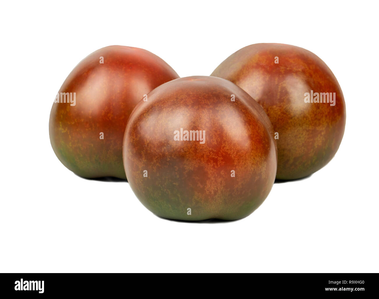 Three ripe kumato tomatoes on white background Stock Photo Alamy