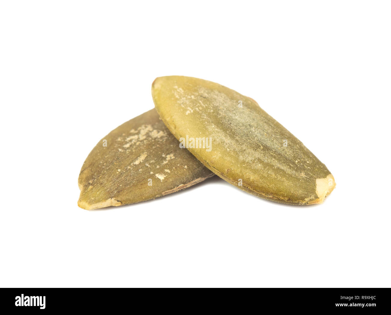 Two pumpkin seeds without shell on white background Stock Photo Alamy