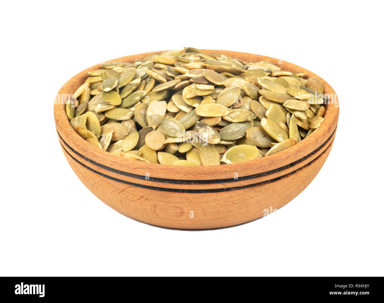 Pumpkin seeds without shell in a bowl on white background Stock Photo
