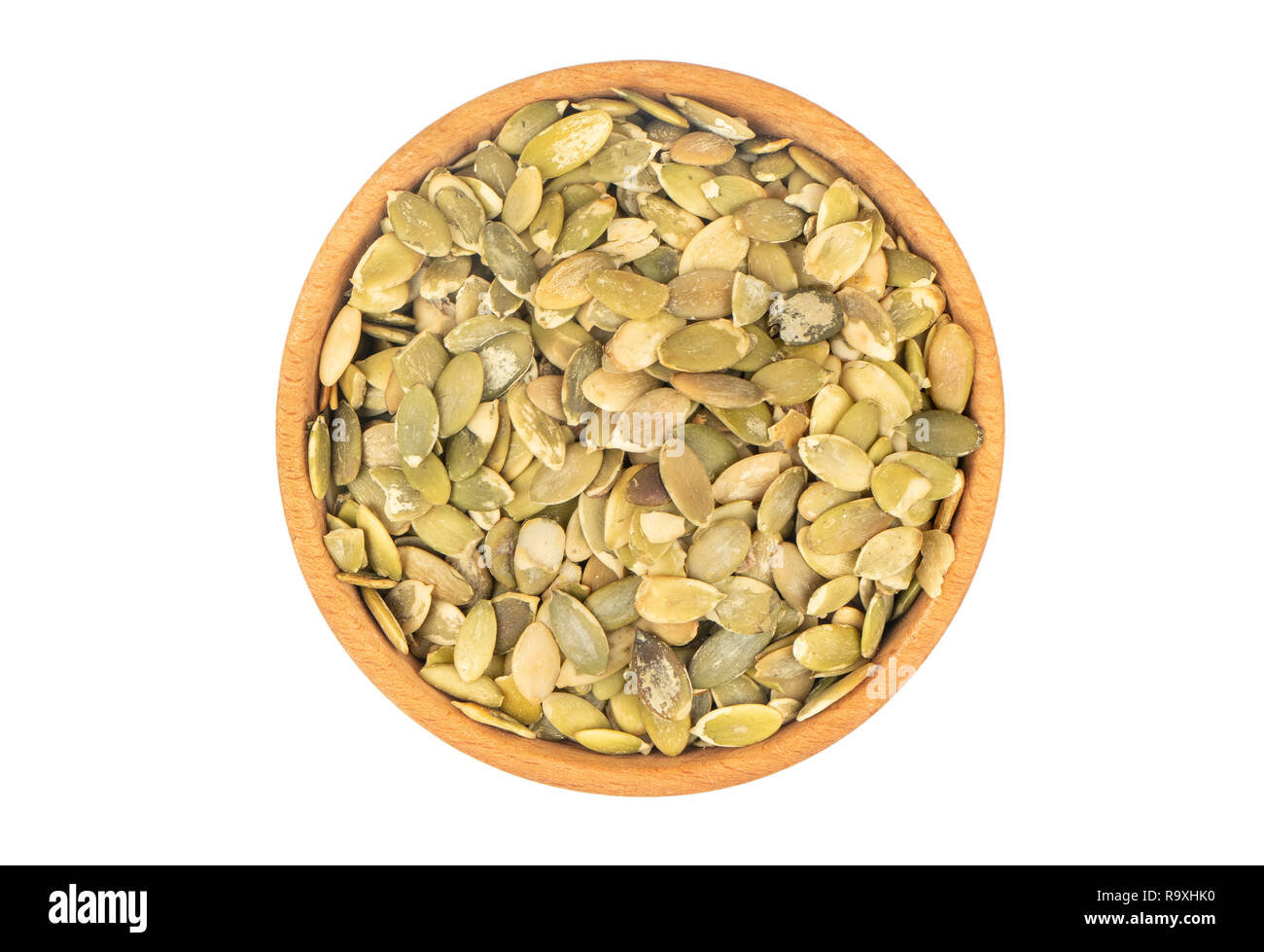 Pumpkin seeds without shell in a bowl on white background Stock Photo