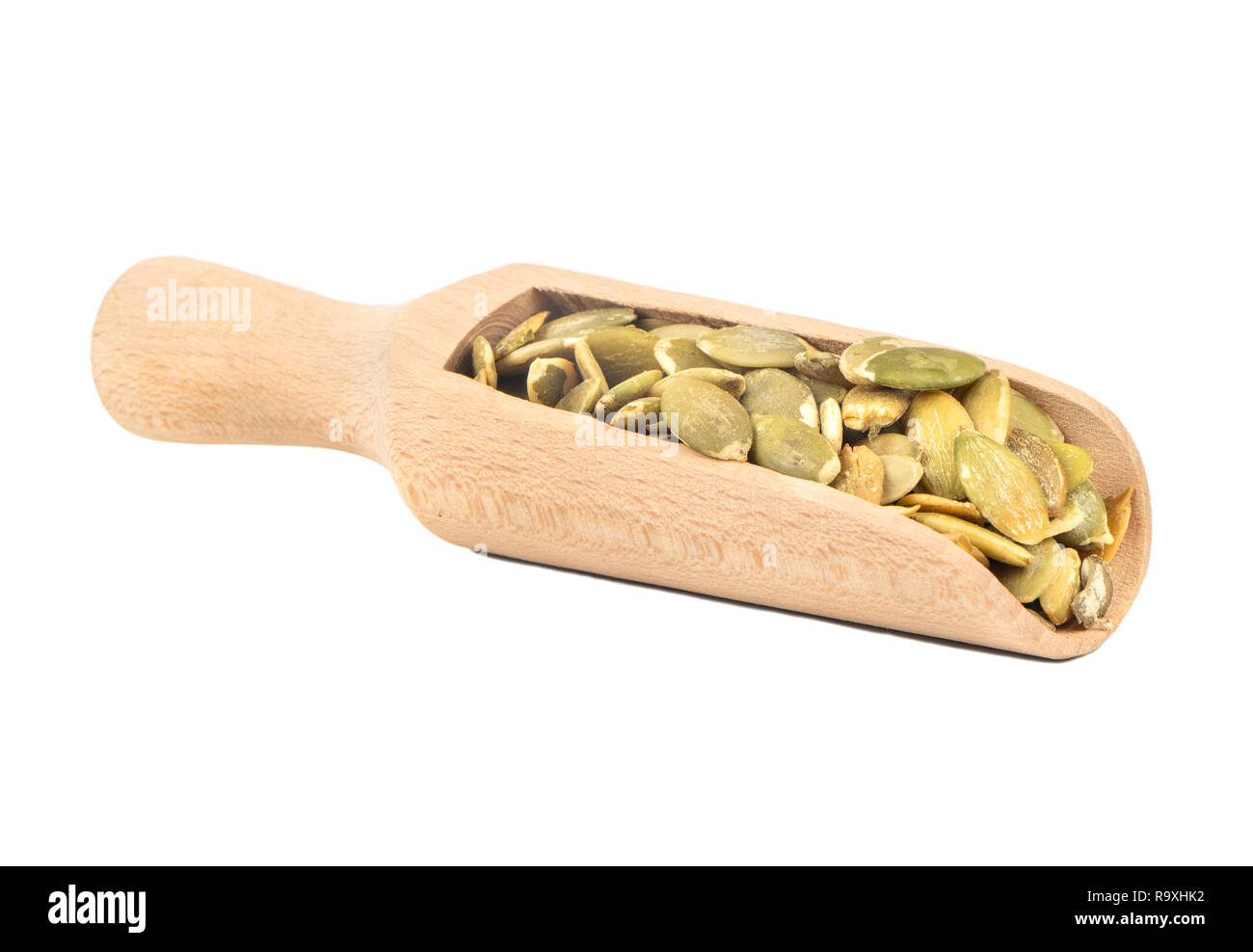 Pumpkin seeds without shell in scoop on white background Stock Photo