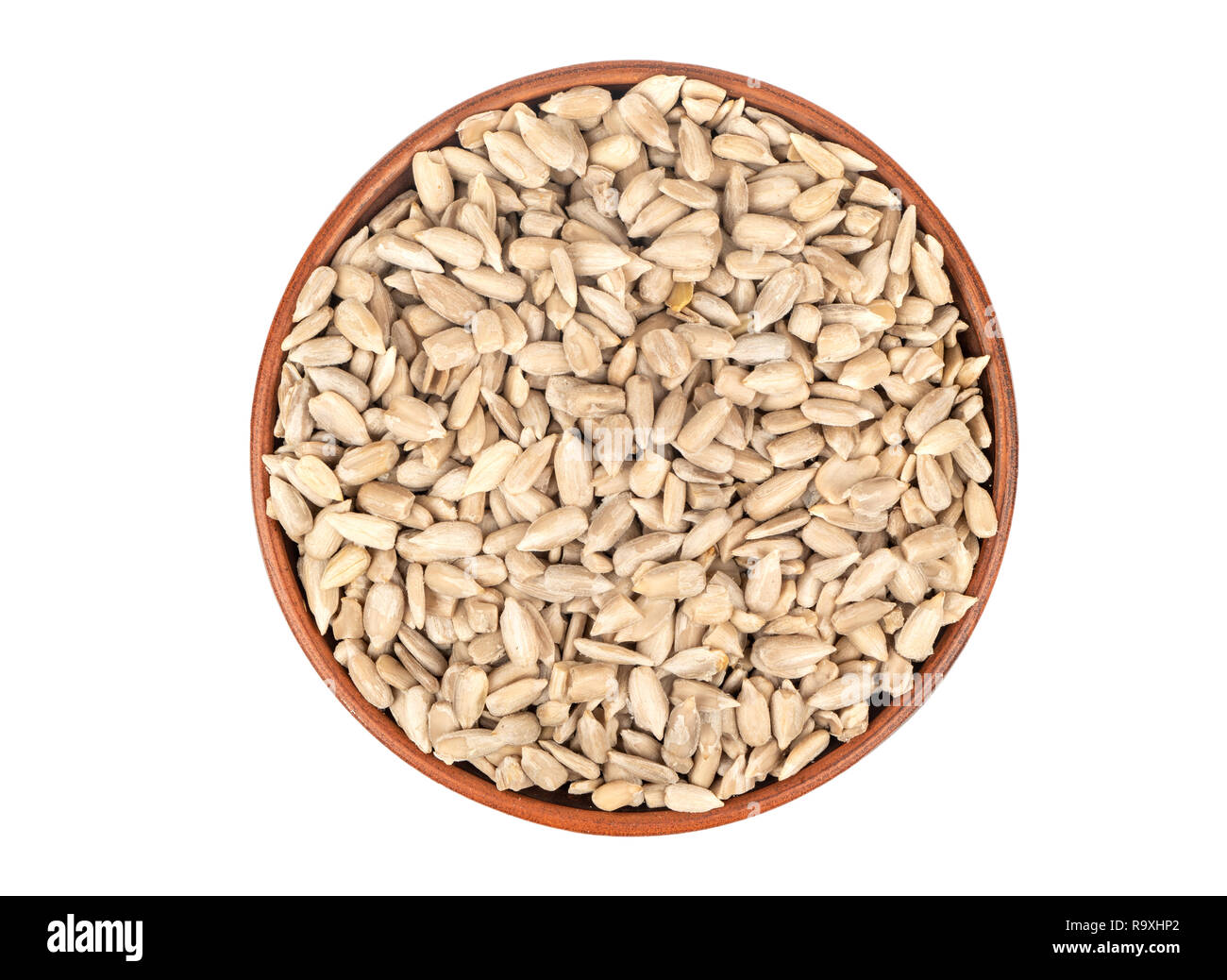 Sunflower seeds without shell in bowl isolated on white background, top