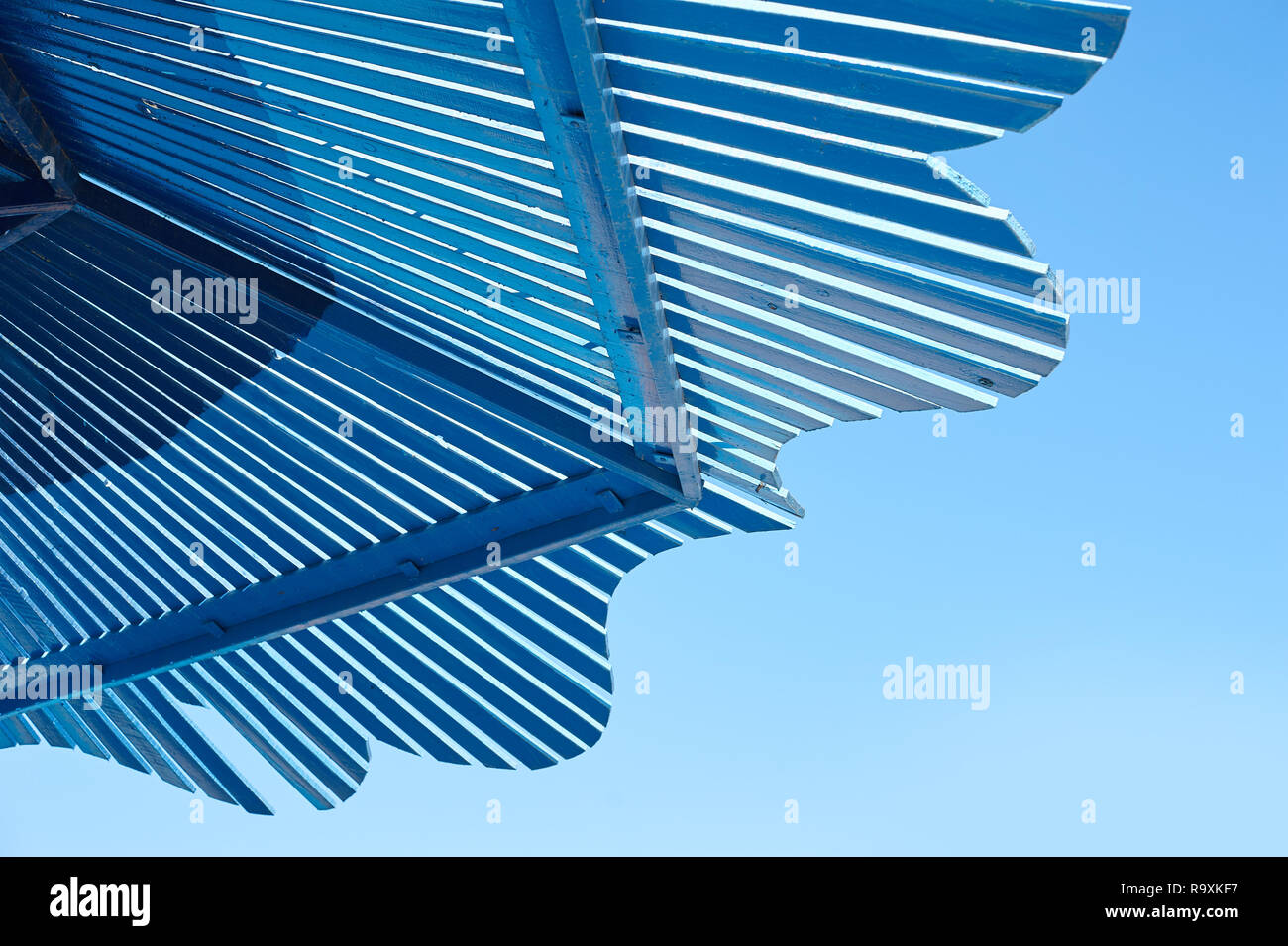 white wooden gazebo roof in the park against blue sky background with ...