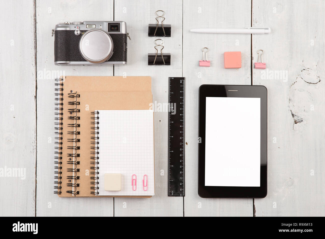 workplace with tablet pc, notepads, camera, ruler and pen. Top view Stock Photo