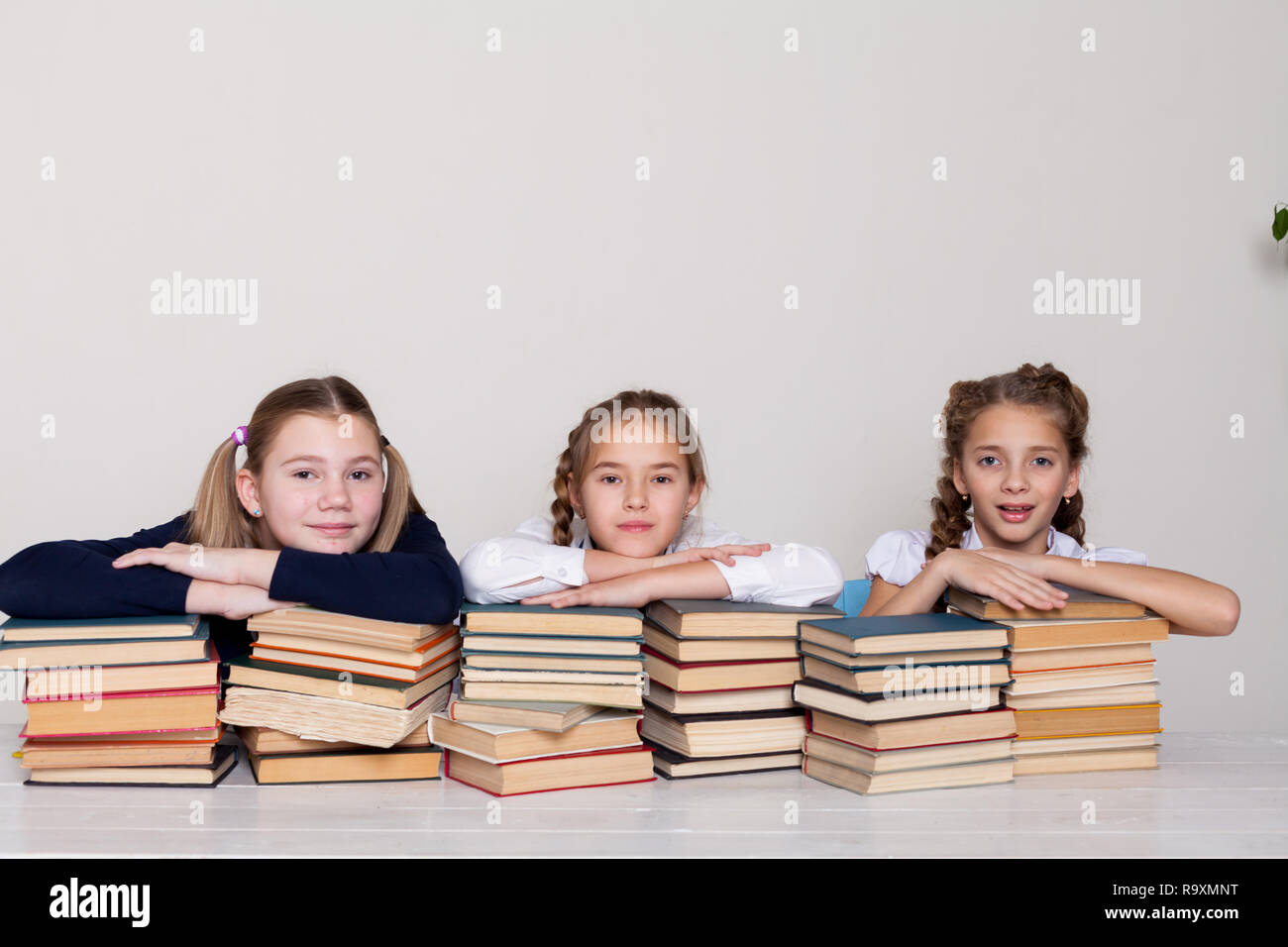 three girls at school in the classroom for books knowledge Stock Photo ...