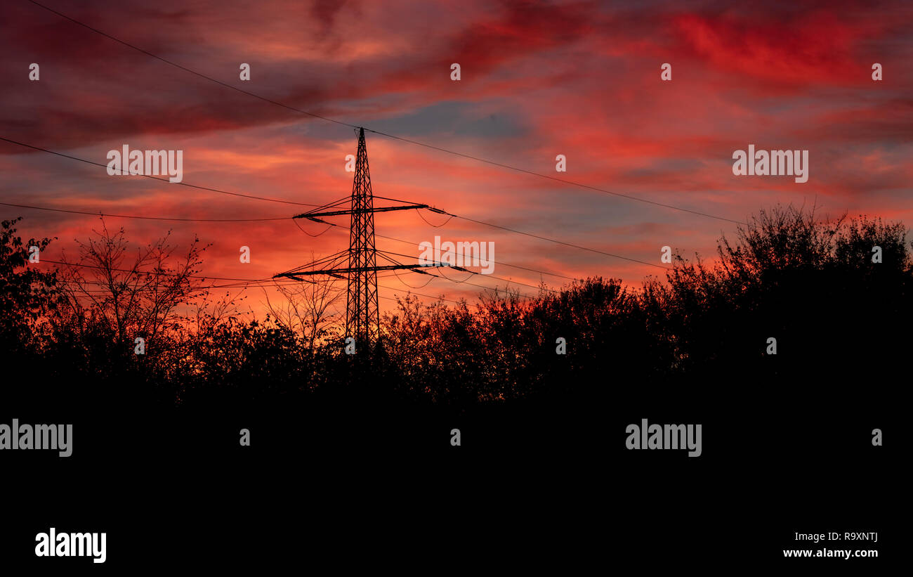 Silhouette of a transmission tower against sundown Stock Photo - Alamy