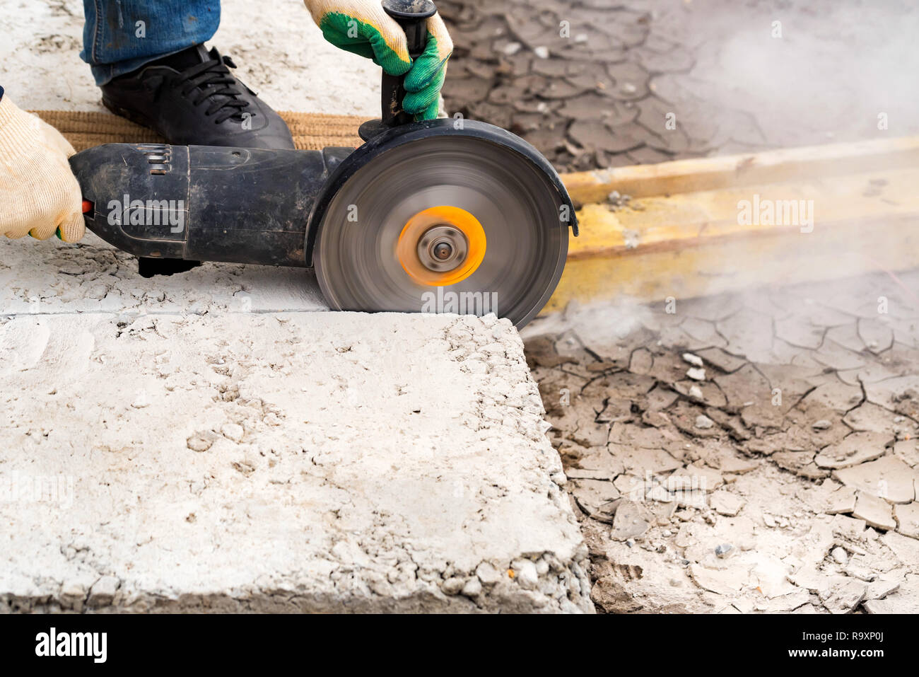 Fragment of a joint cutter on a brushed concrete surface. The diamond
