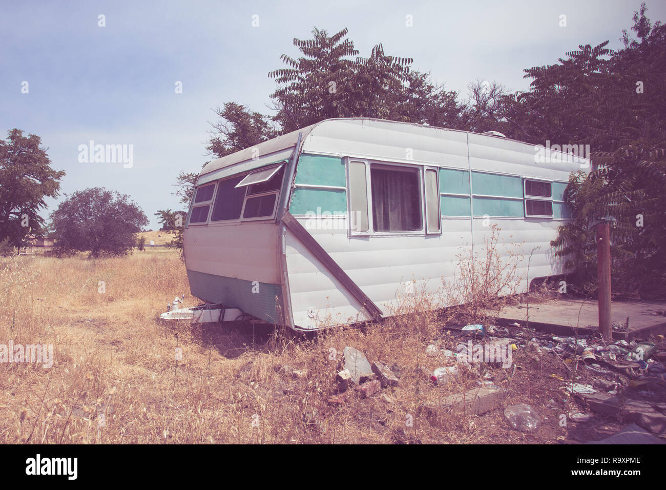 Vintage broken down RV camper trailer with retro toned effect Stock Photo