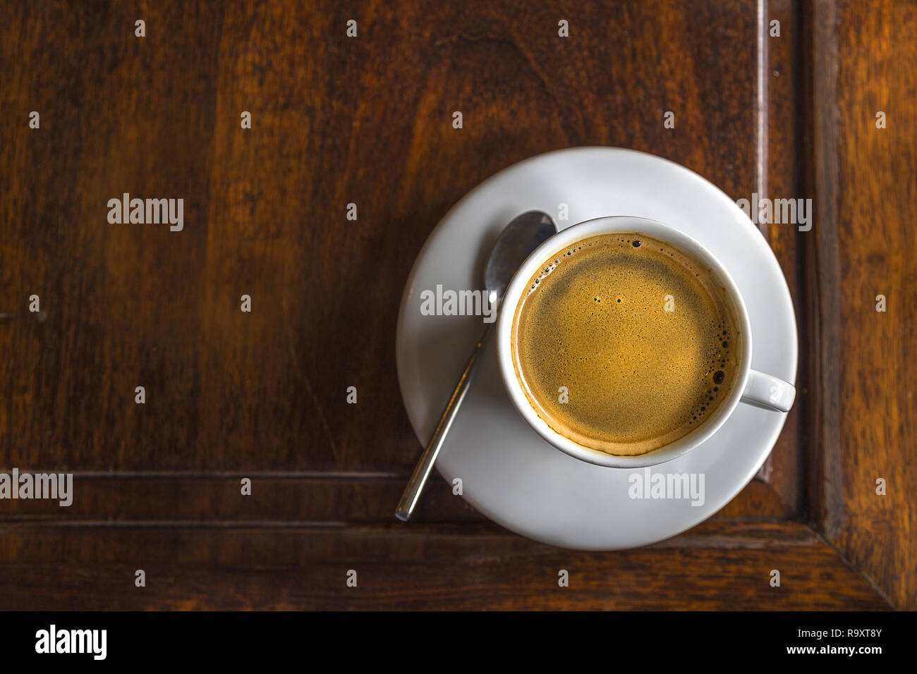 Vietnamese Coffee served on a wood table in Hanoi. Just poured with foam still on top Stock