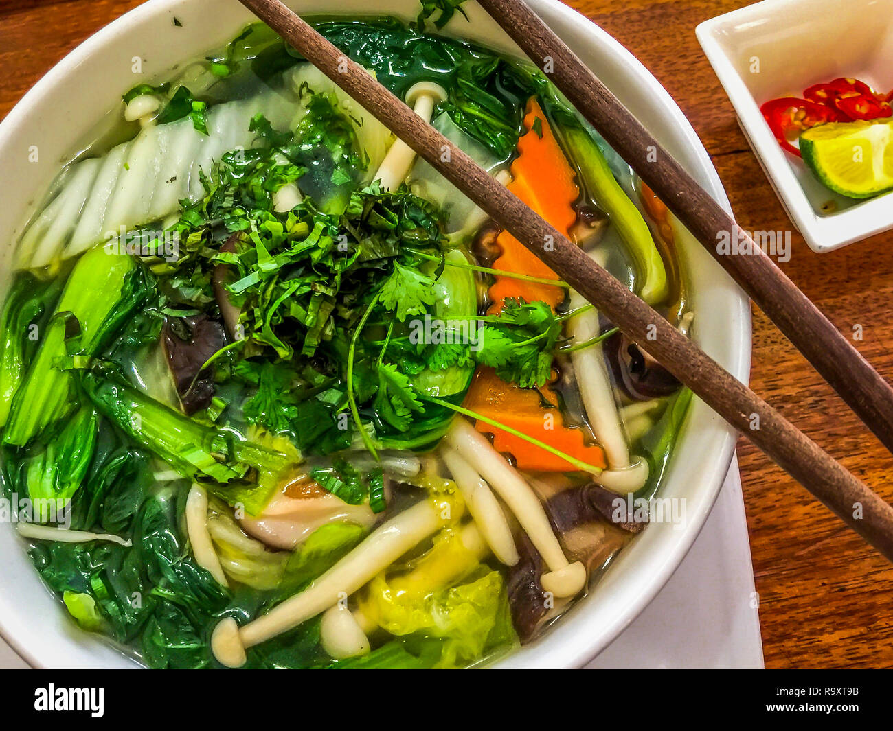 vegetable Pho soup in Vietnam with fresh mushrooms, carrots, bok choy