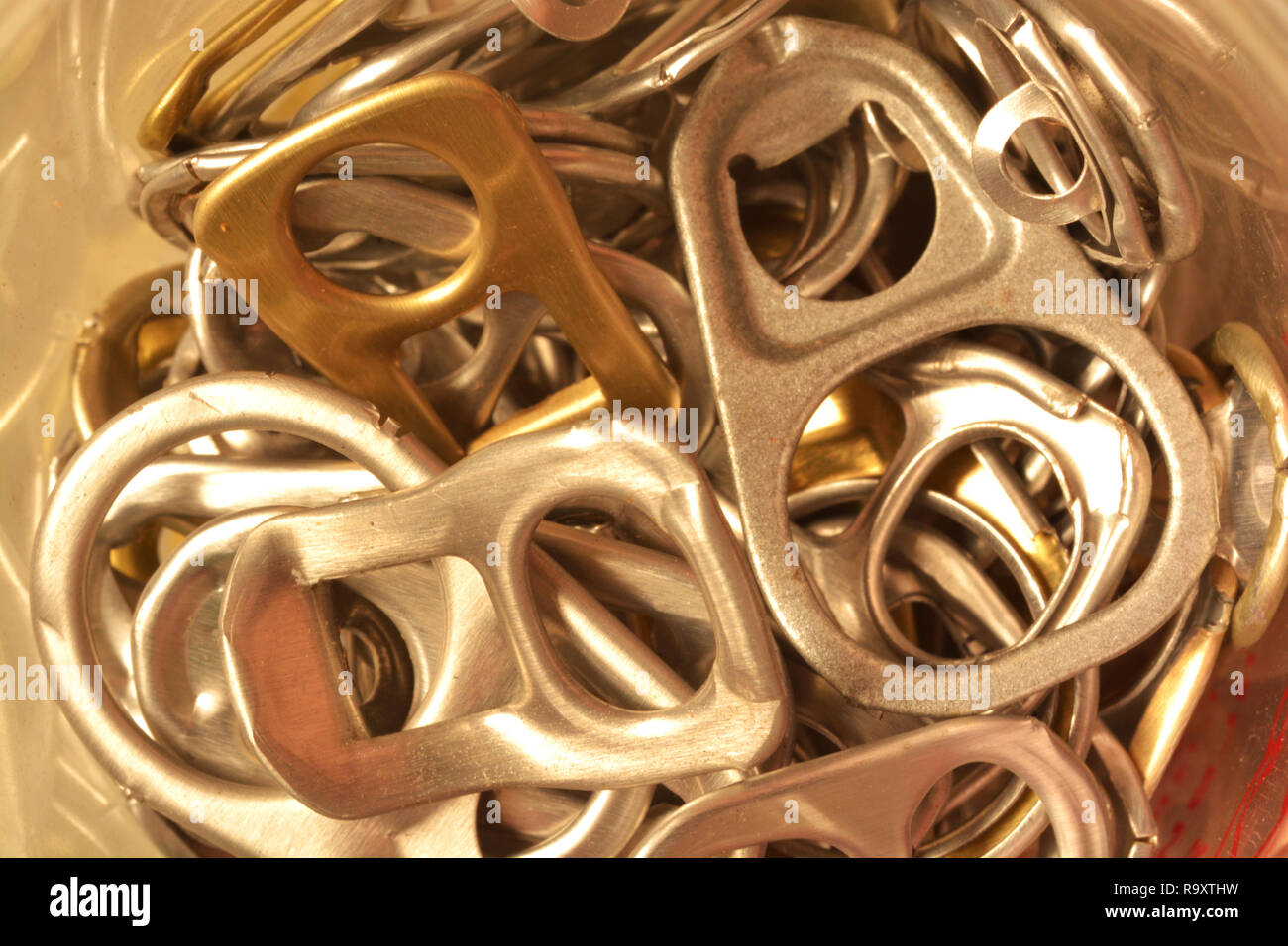 Background of many ring pull can opener, silver and gold. Stock Photo