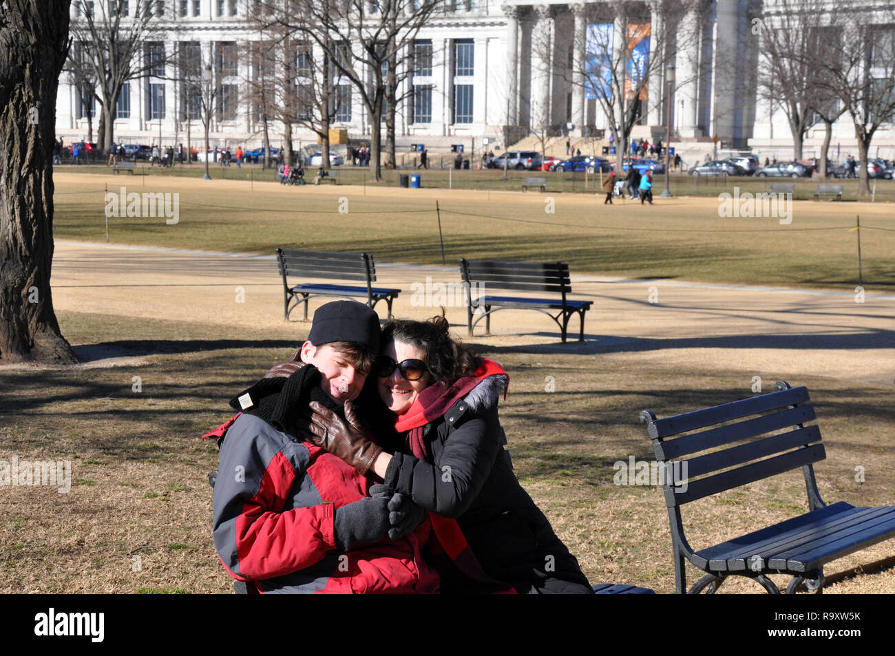 Woman with Autistic Son Seated on Bench at the National Mall near the National Gallery of Art, Washington DC Stock Photo