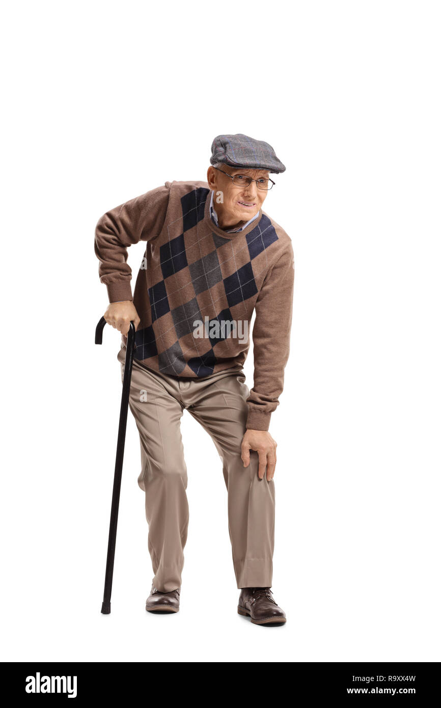 Full length portrait of a senior man with a knee pain walking with a cane isolated on white