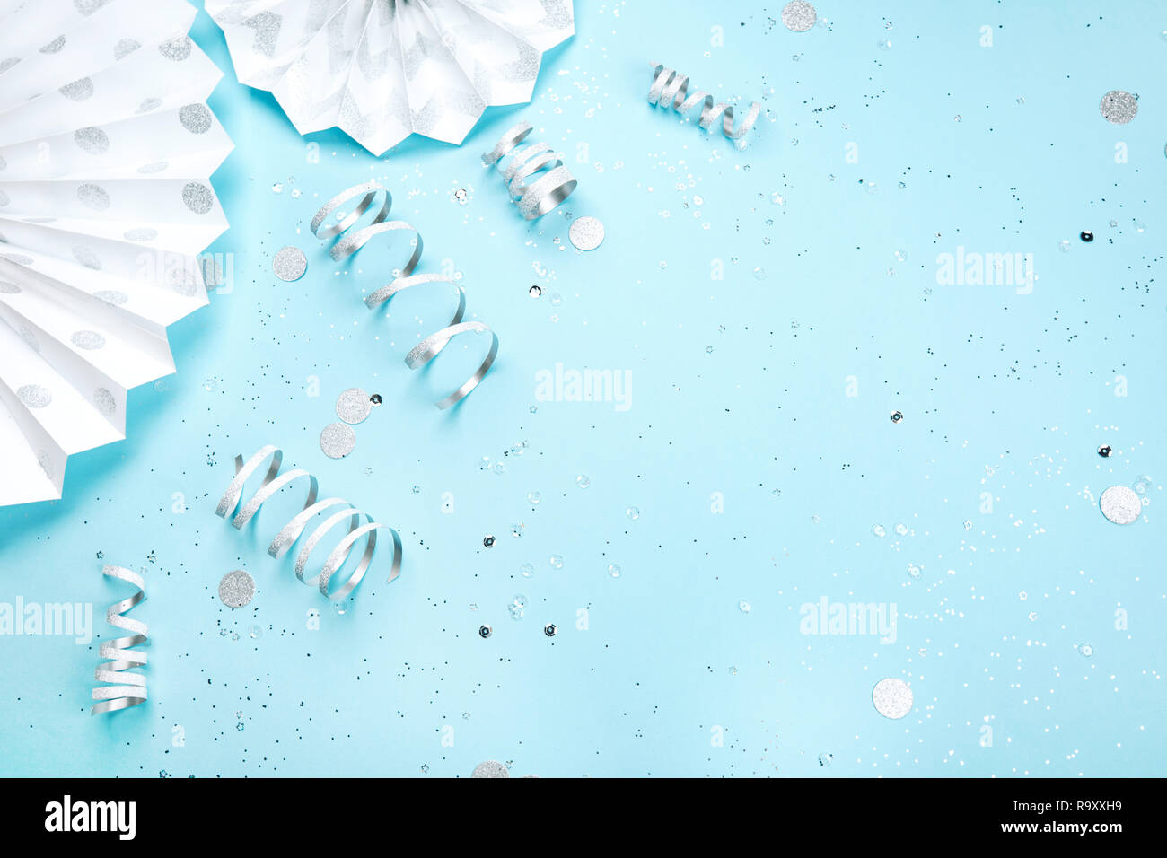 Holiday Frame Is Made Of Silver And White Decorations And Sparkling Confetti On Blue Pastel Background Festive Concept Place For Text Stock Photo Alamy
