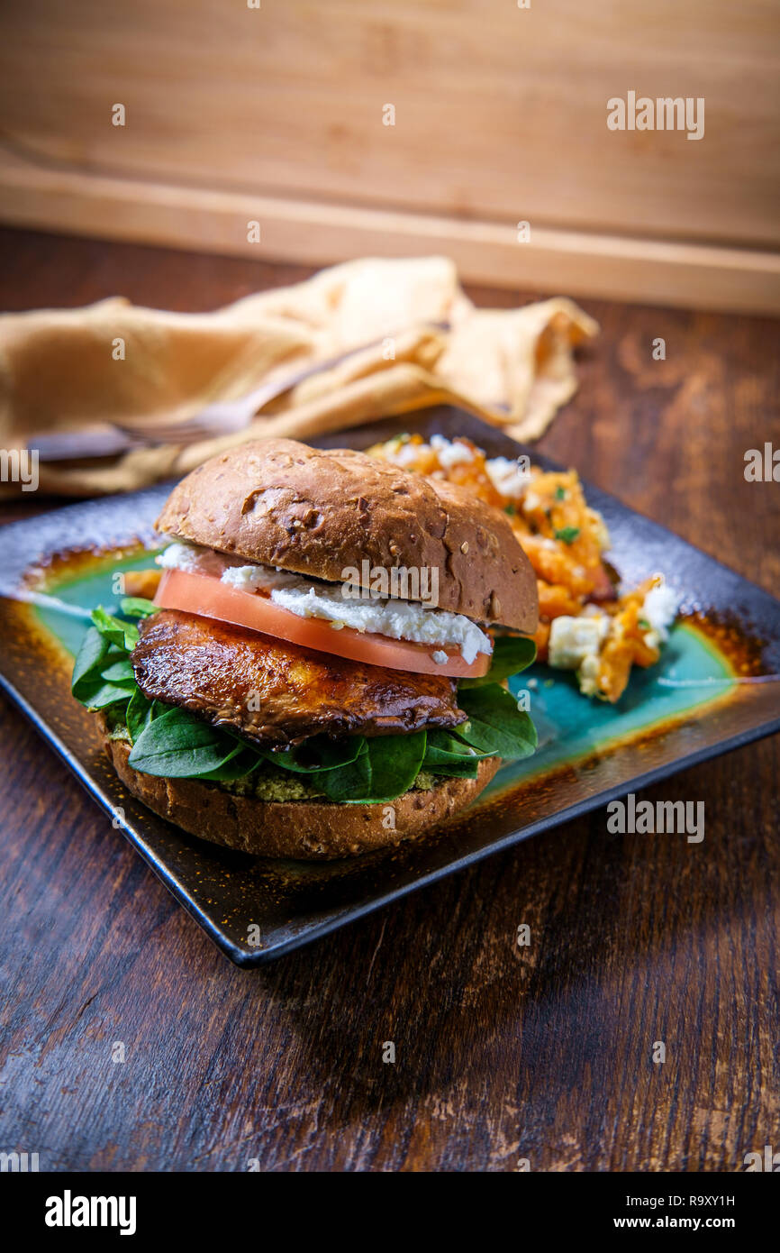 Portobello mushroom sandwich with goat cheese pesto and side of Greek sweet potato fries Stock
