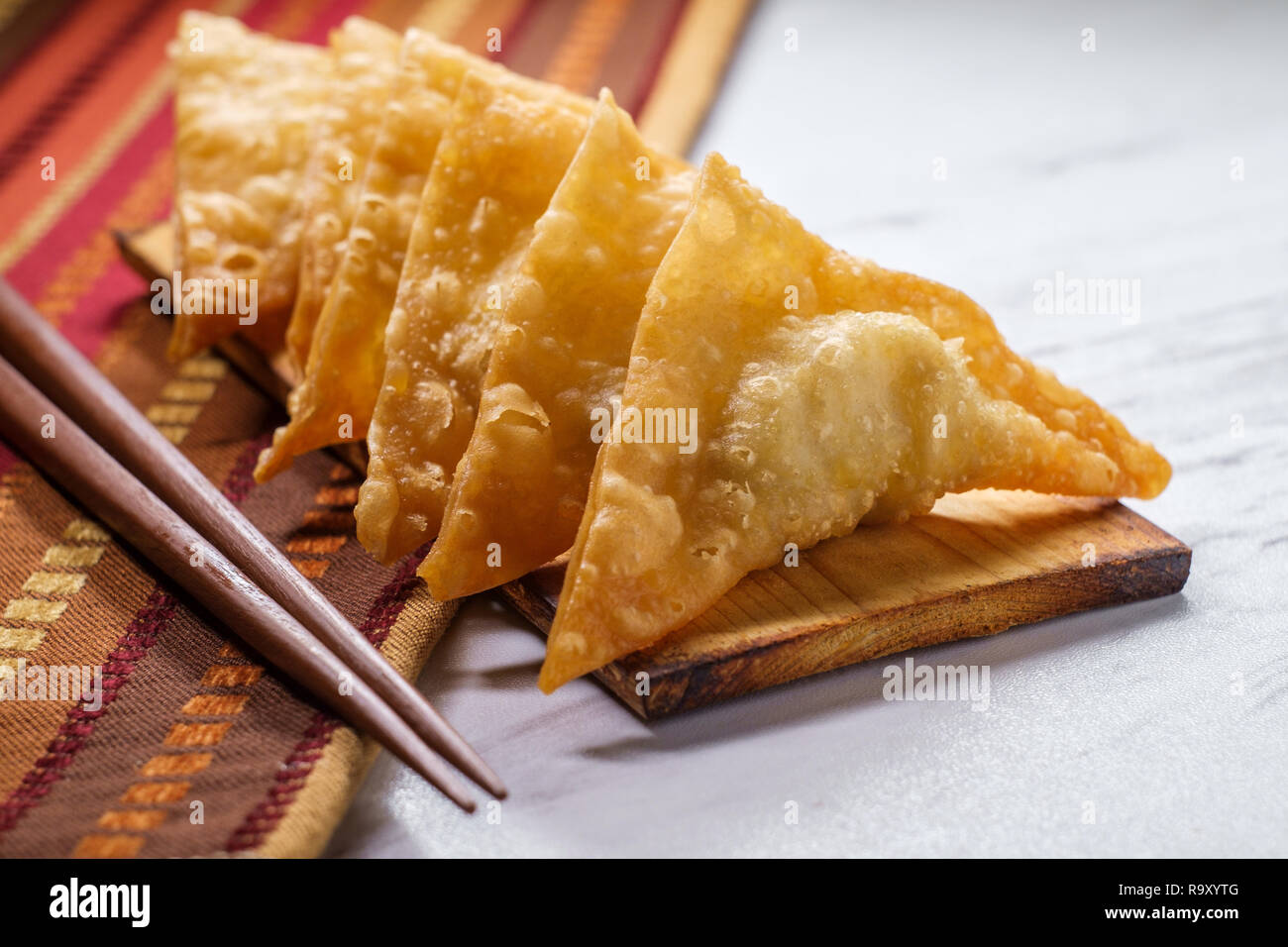 Authentic crispy Korean deepfried mandu dumplings on wooden plate
