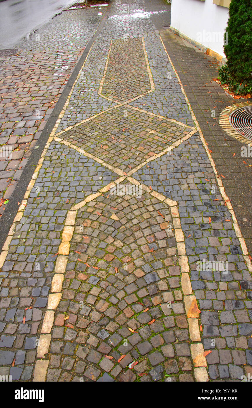 Paths and walkways made from small dressed stone blocks, some centuries ...