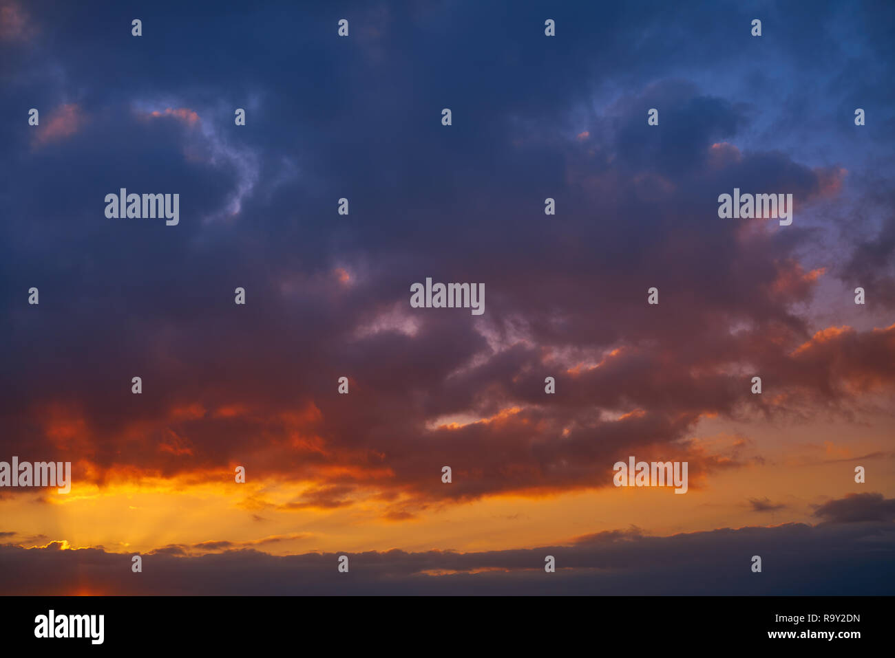 Sunset sky clouds orange and blue colors Stock Photo