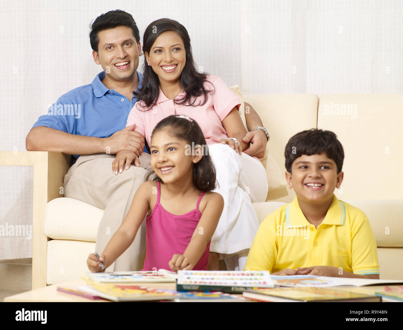 PARENTS WATCHING THEIR CHILDREN STUDYING AND DRAWING IN THEIR HOME ...