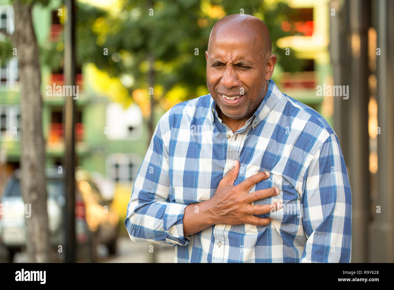African American man having pains holding his chest. Stock Photo