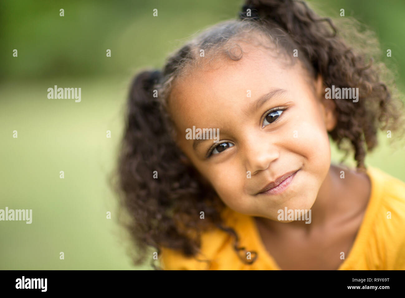Cute Mixed Race Little Girl Laughing And Smiling Stock Photo