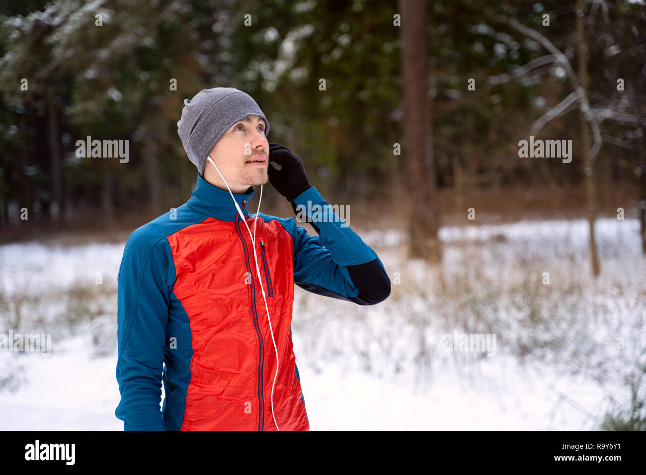 Portrait of a runner dressed in warm sportswear awaiting the start of winter outdoor training. Stock Photo