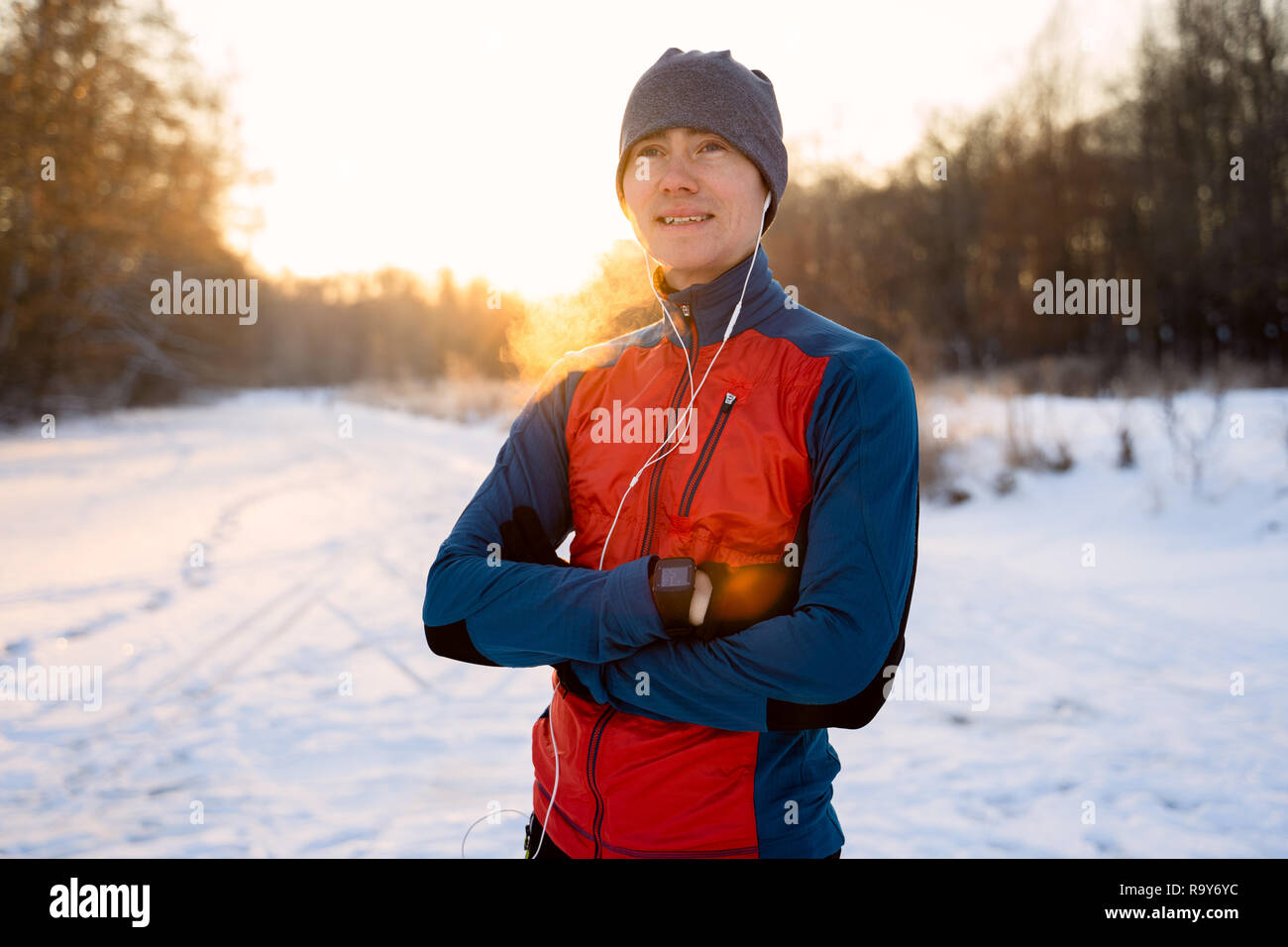 Portrait of a runner dressed in warm sportswear awaiting the start of winter outdoor training. Stock Photo