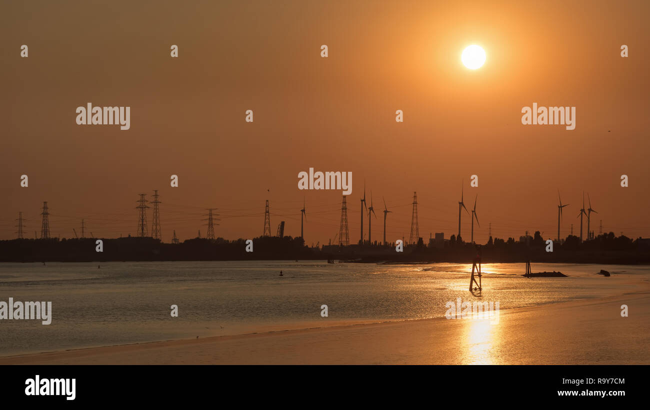 Sunset at a riverbank, Port of Antwerp, Belgium Stock Photo Alamy
