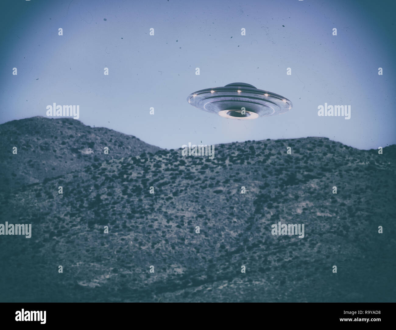 Unidentified flying object UFO. Old style photo with high ISO noise and dirt with scratches over time. Clipping path included. Stock Photo