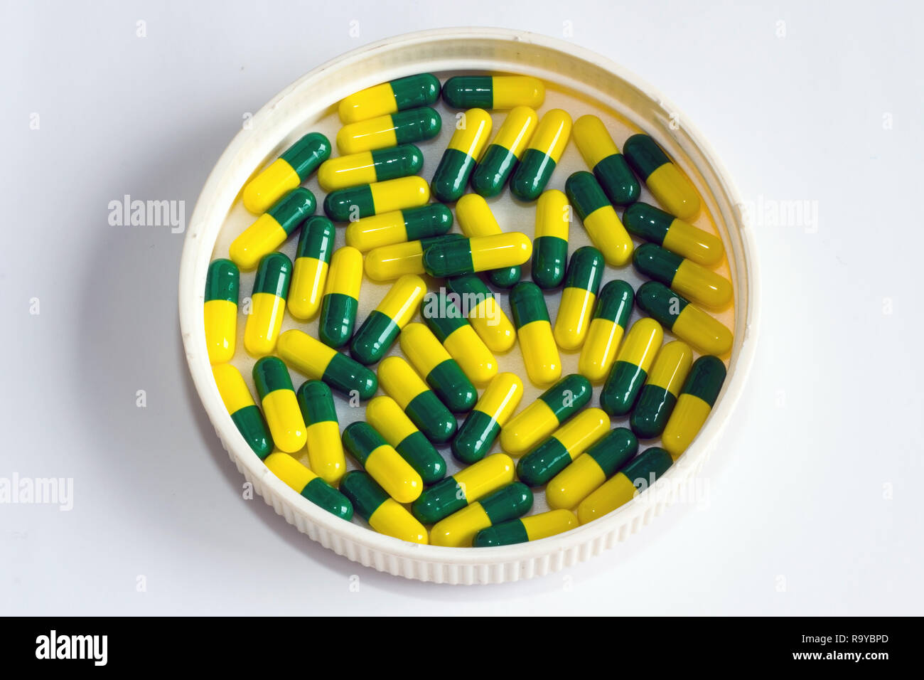 green yellow capsule drug isolated white background Stock Photo Alamy