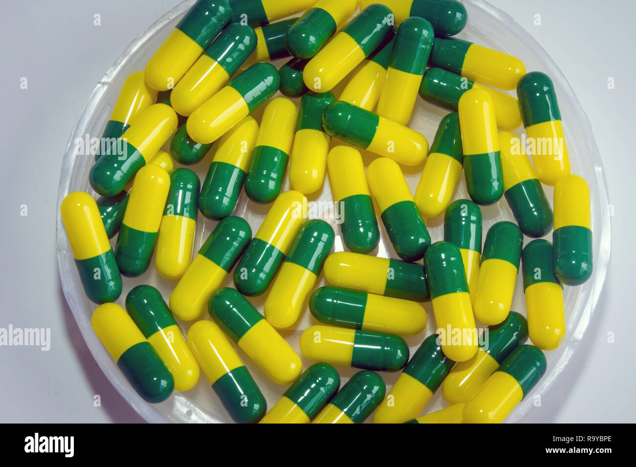 green yellow capsule drug isolated white background Stock Photo Alamy