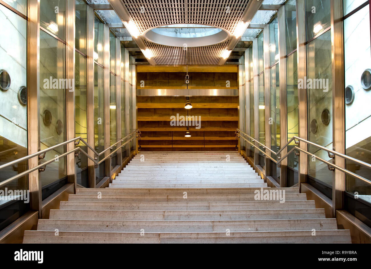 Front view of a staircase with metal railing leading to up Stock Photo