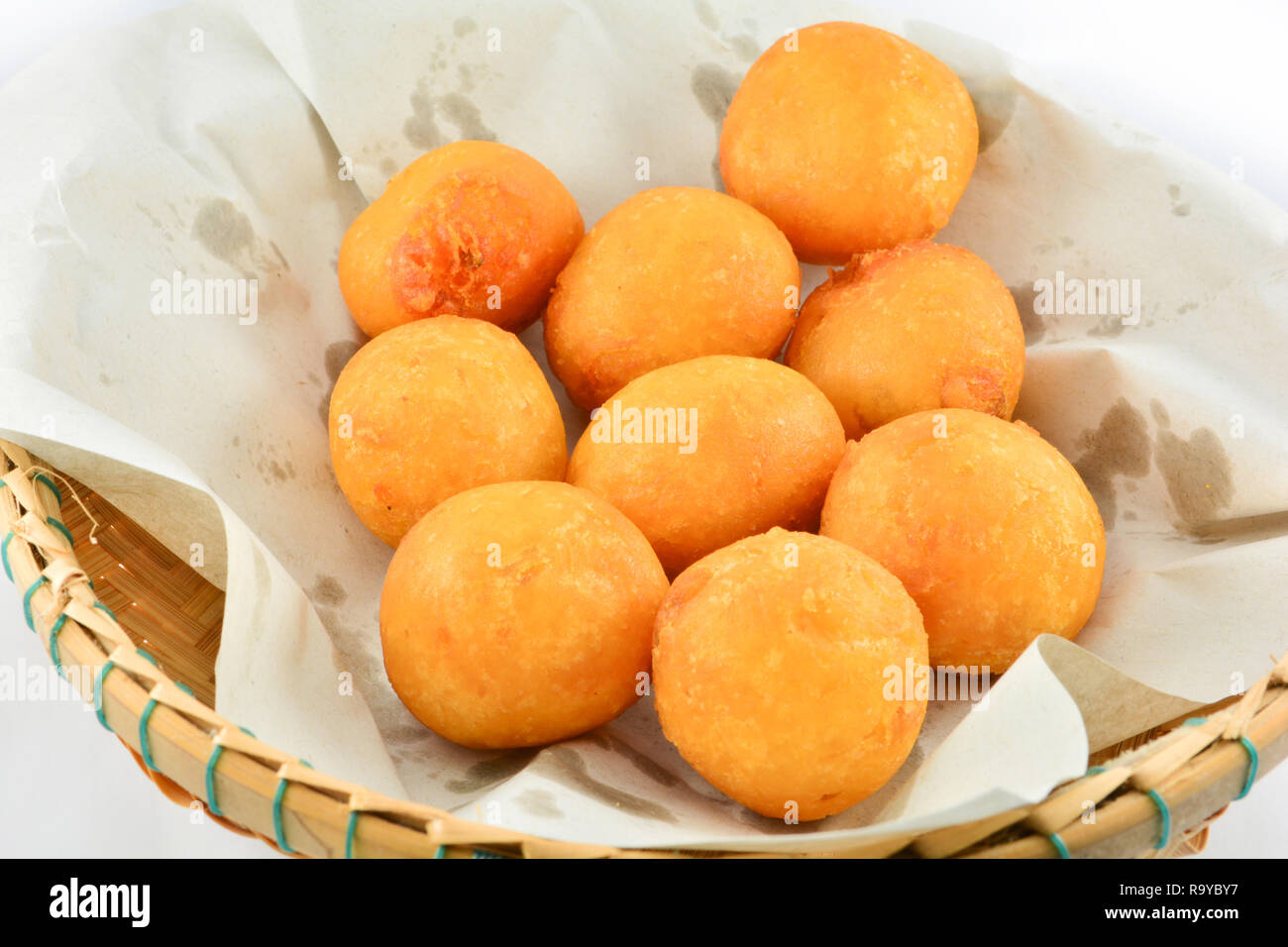 Thai Fried Sweet Potato Balls / general desserts for Snack in basket on white background Stock