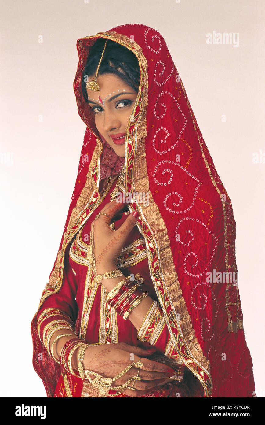 A PORTRAIT OF A Bride FROM RAJASTHAN dressed in traditional costume and