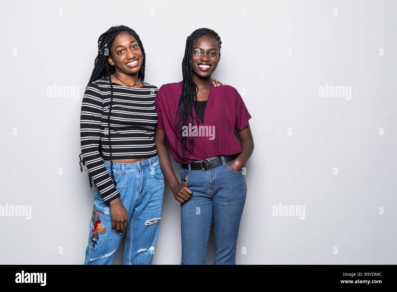 African Two women standing on white background Stock Photo - Alamy