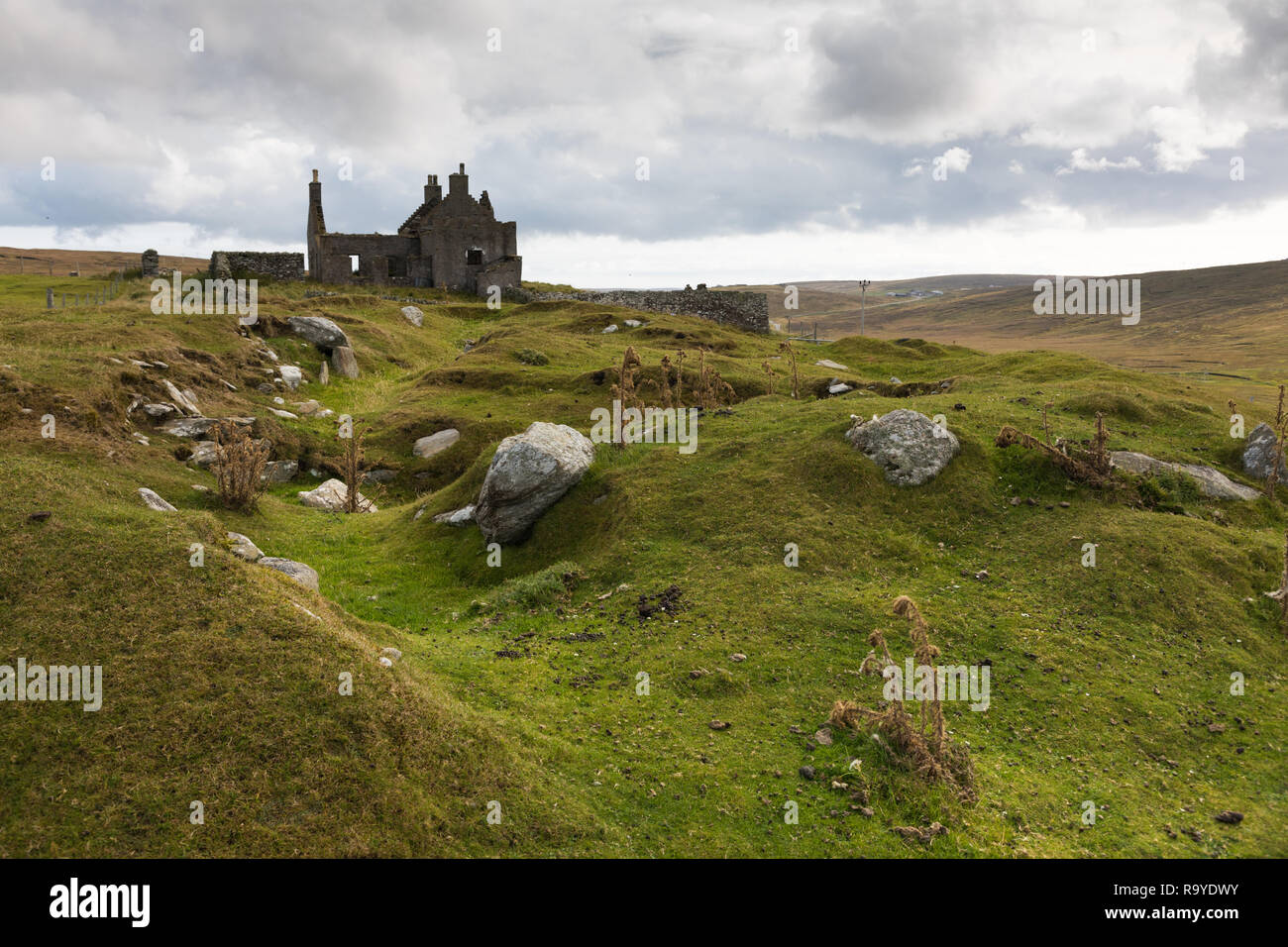 Ruins of an old manor with the remains of a broch in front on Shetland, Yell Stock Photo